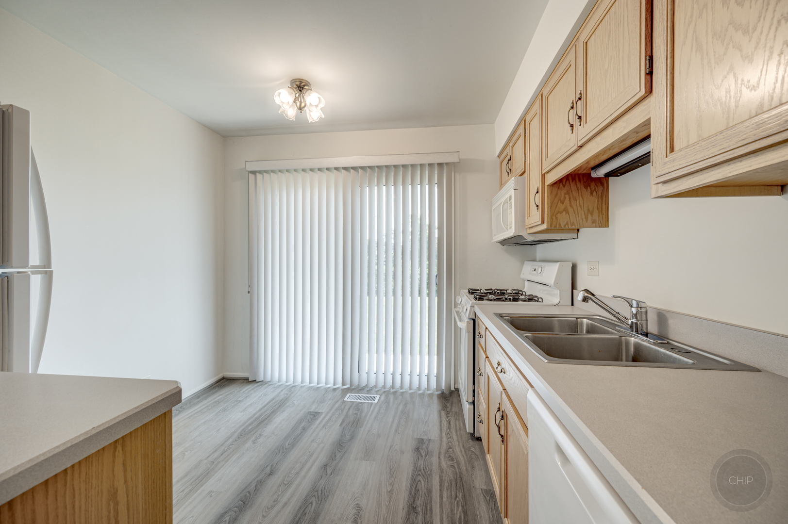 360 Springlake Lane, Unit B Aurora, IL 60504 - Photo 9 of 26 a kitchen with a sink a stove and cabinets