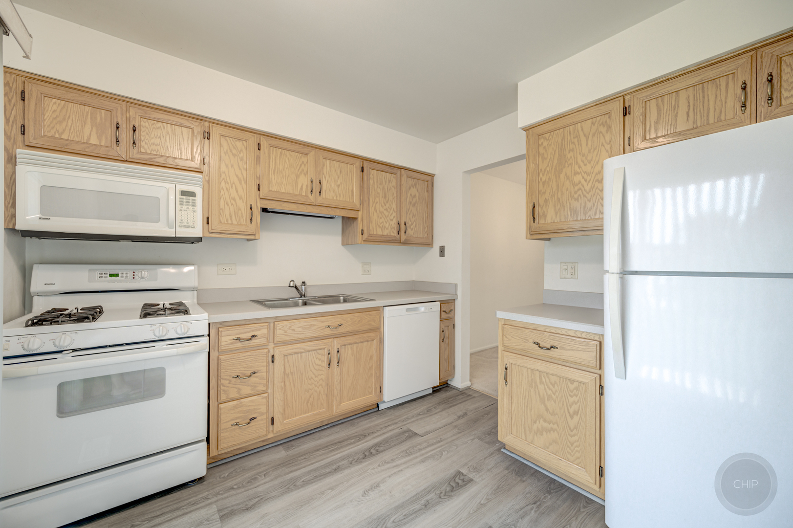 360 Springlake Lane, Unit B Aurora, IL 60504 - Photo 10 of 26 a kitchen with a white cabinets and white appliances