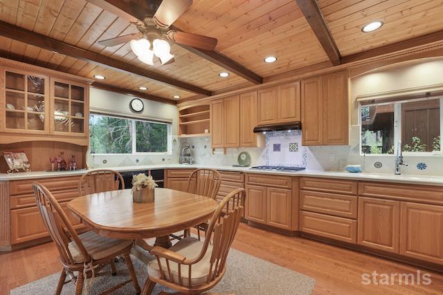 1429 Chinquapin Drive South Lake Tahoe, CA 96150 - Photo 12 of 37 a kitchen with stainless steel appliances granite countertop a sink table and chairs