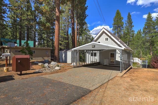 1429 Chinquapin Drive South Lake Tahoe, CA 96150 - Photo 2 of 37 a front view of a house with a yard and garage