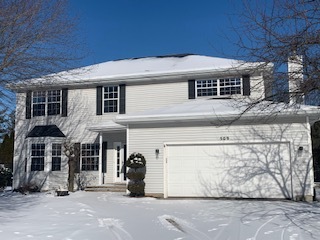 509 Oak Crest Drive North Aurora, IL 60542 - Photo 1 of 57 a front view of a house with parking space