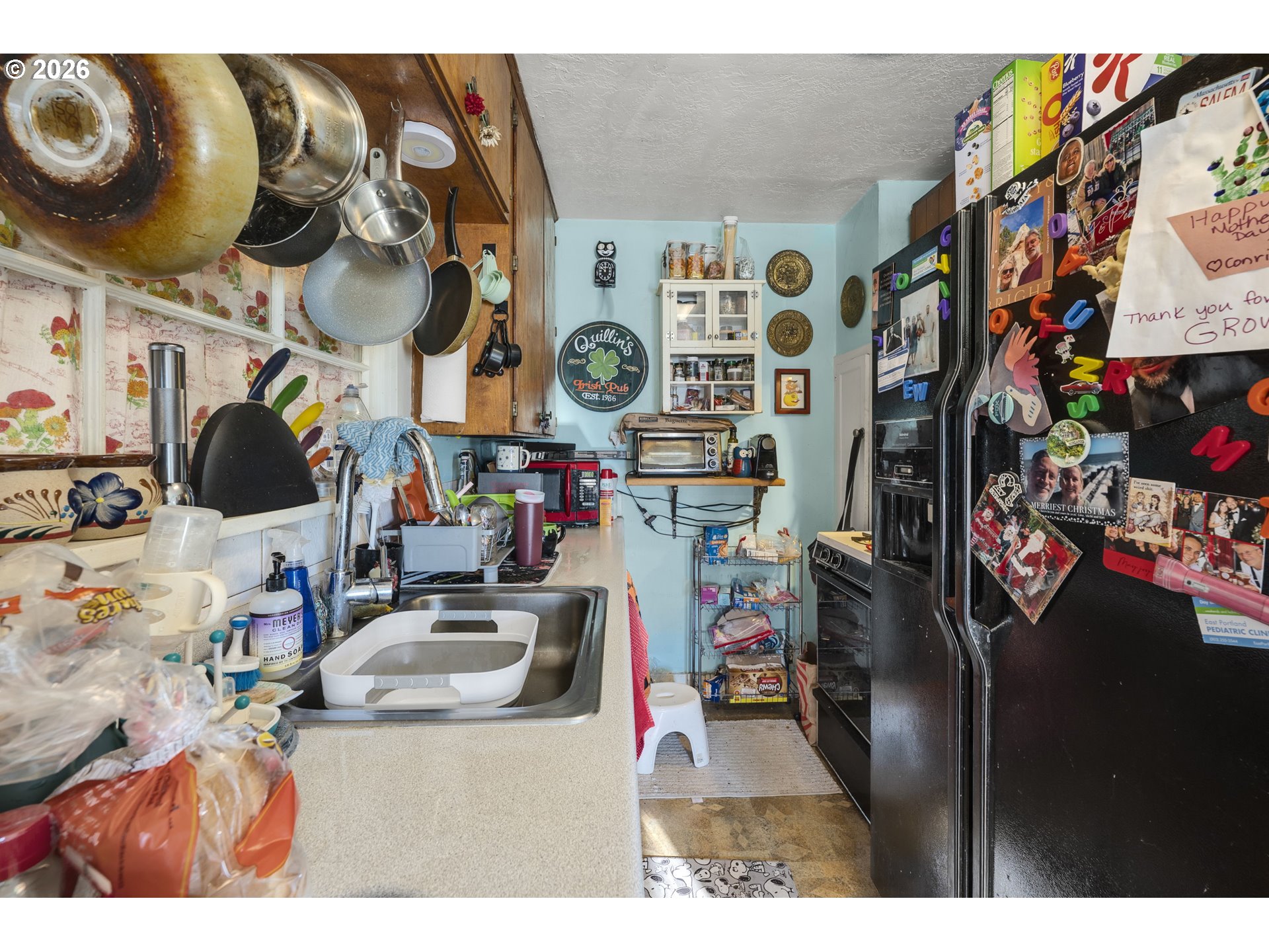 1601 Southeast 130th Avenue Portland, OR 97233 - Photo 16 of 35 a utility room with lots of clutter and refrigerator