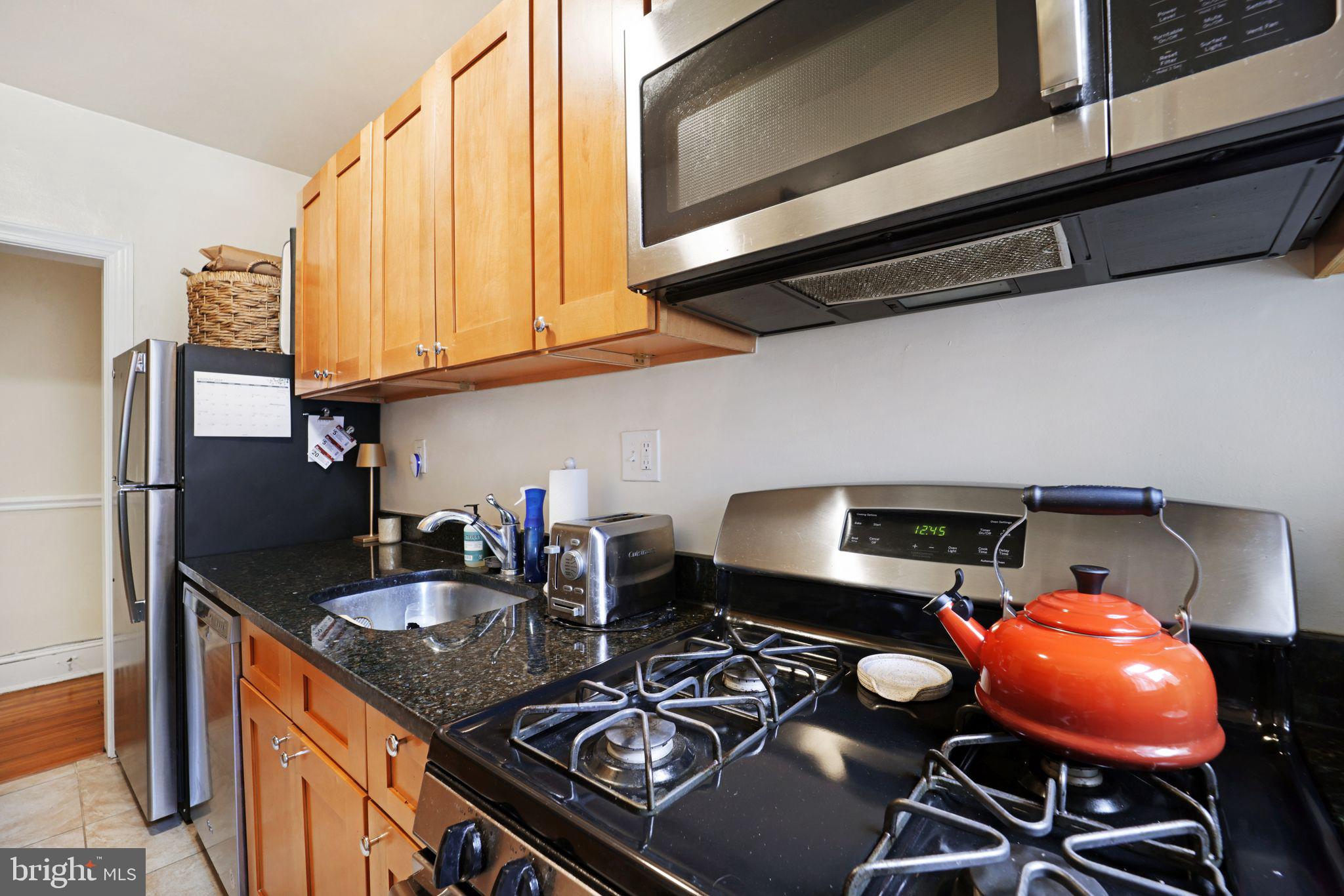 1426 12th Street Northwest, Unit 5 Washington, DC 20005 - Photo 9 of 21 a kitchen with stainless steel appliances granite countertop a stove and a sink
