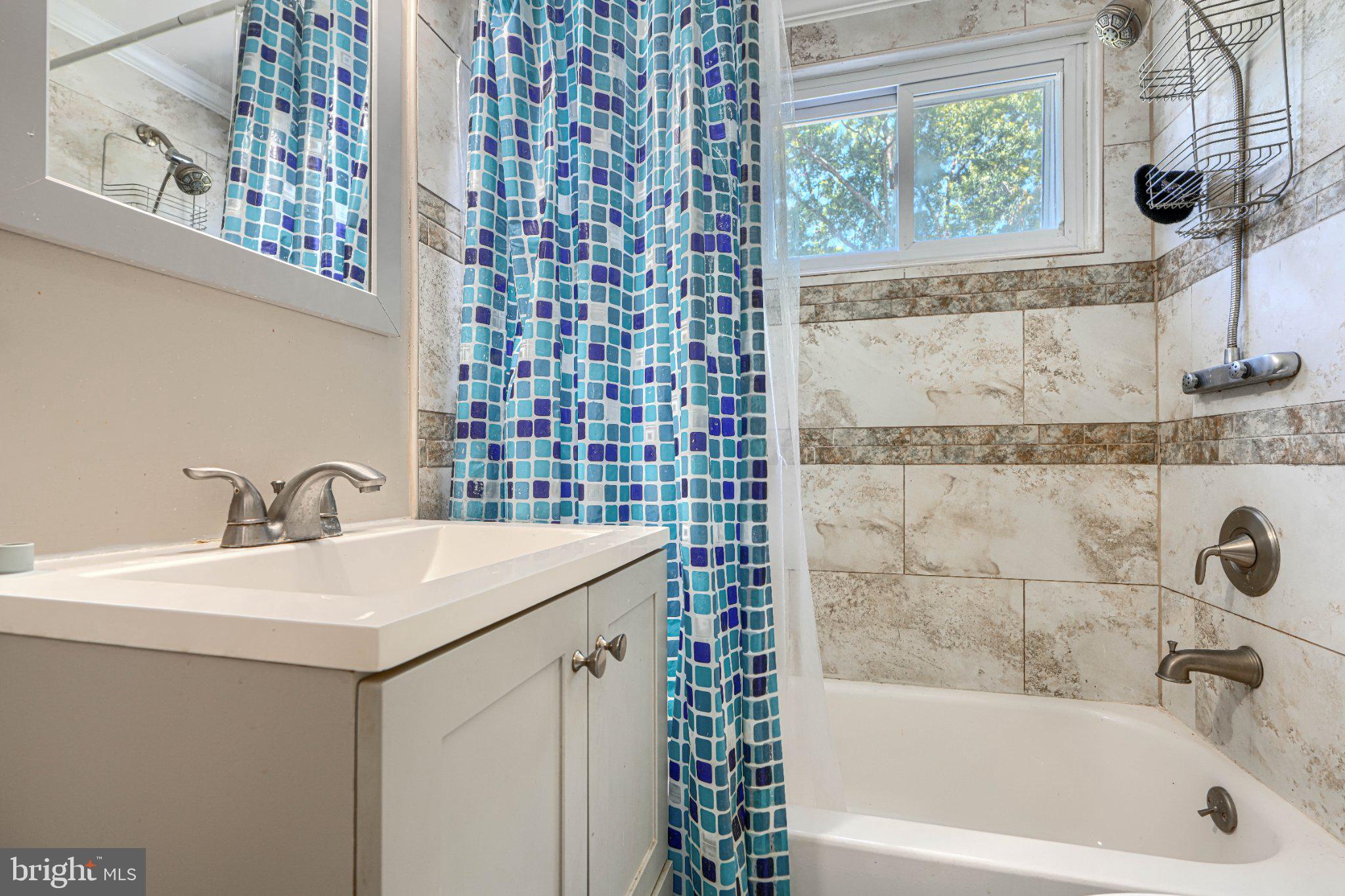 3708 Cassen Road Randallstown, MD 21133 - Photo 29 of 38 a bathroom with a sink a mirror and a bathtub