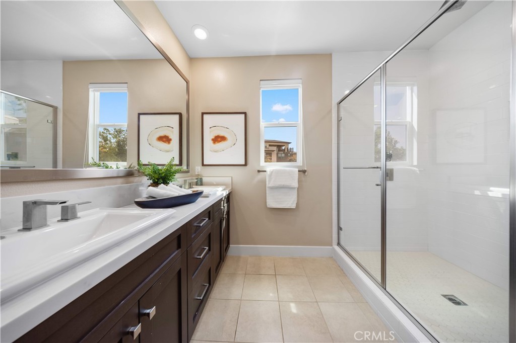 125 Character Irvine, CA 92618 - Photo 27 of 74 a spacious bathroom with a shower sink and mirror