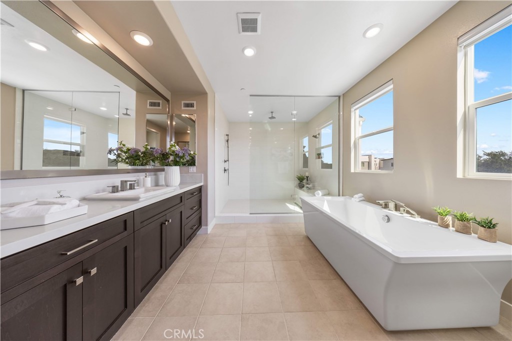 125 Character Irvine, CA 92618 - Photo 39 of 74 a large bathroom with a large tub sink vanity granite and mirror