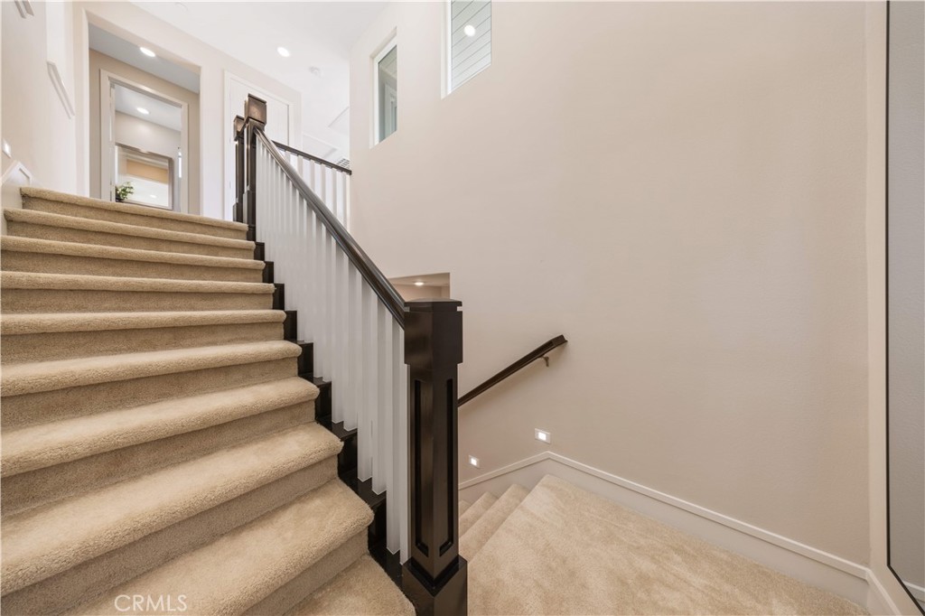 125 Character Irvine, CA 92618 - Photo 54 of 74 a view of staircase with lots of frames on wall and a window