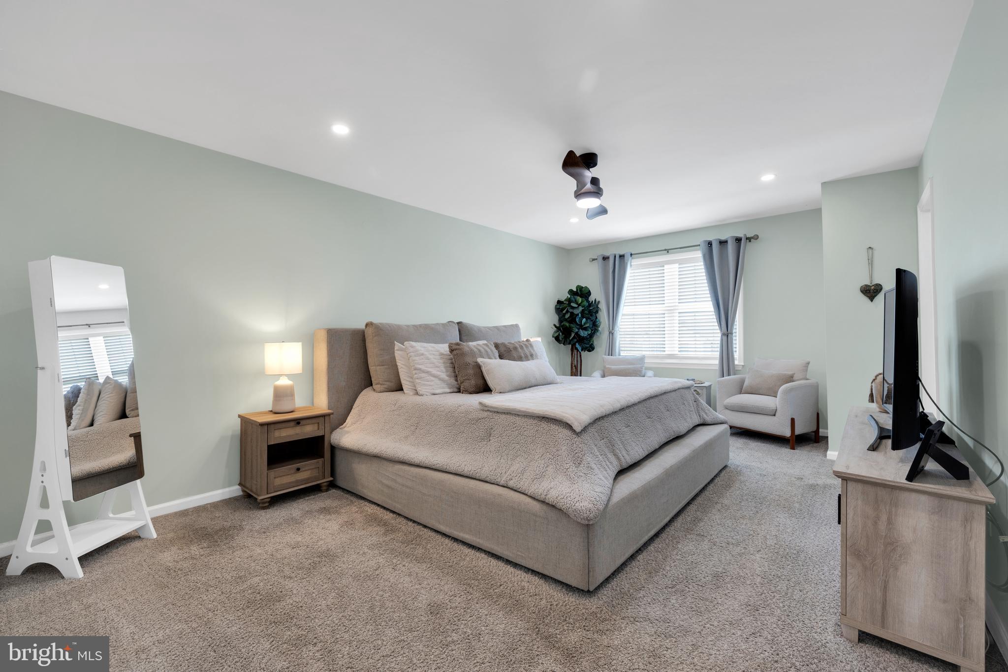 1548 Huron Drive Sinking Spring, PA 19608 - Photo 14 of 32 a spacious bedroom with a bed and a flat screen tv
