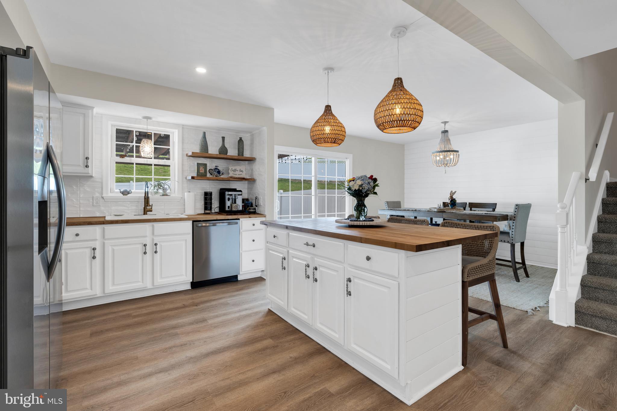 1548 Huron Drive Sinking Spring, PA 19608 - Photo 7 of 32 a kitchen with granite countertop a sink cabinets stainless steel appliances and a large window
