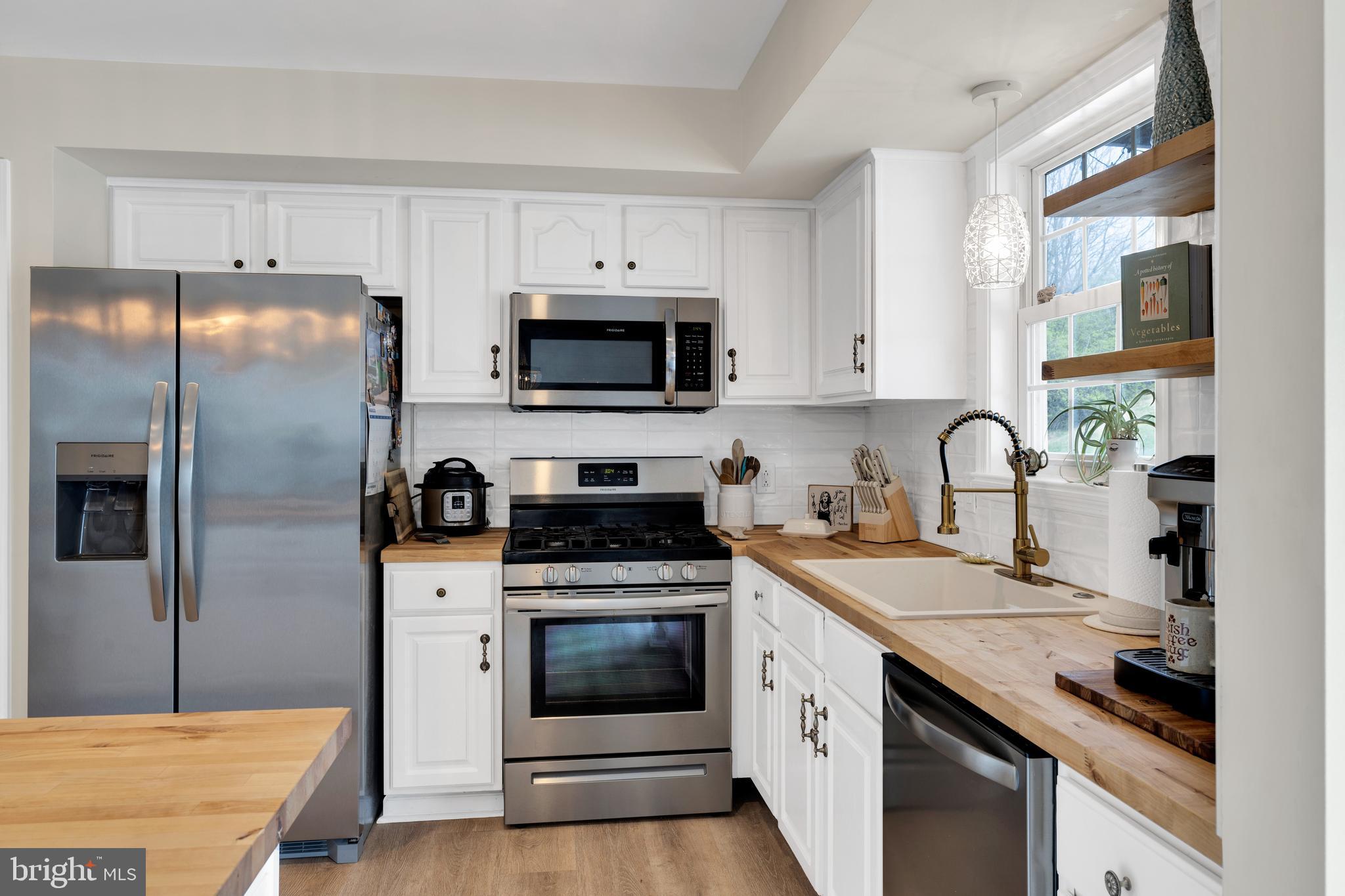 1548 Huron Drive Sinking Spring, PA 19608 - Photo 9 of 32 a kitchen with a sink stove and refrigerator