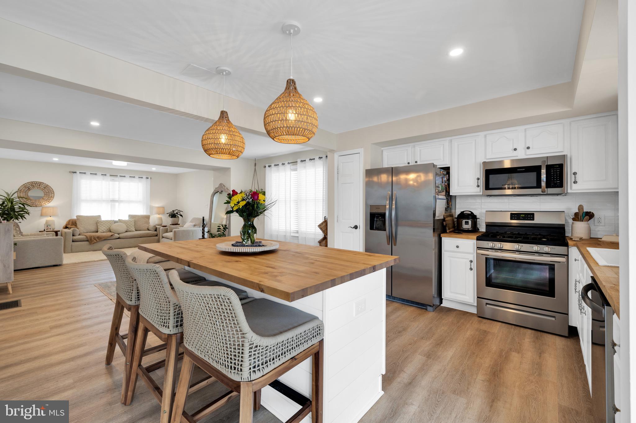 1548 Huron Drive Sinking Spring, PA 19608 - Photo 10 of 32 a kitchen with a table chairs refrigerator and microwave