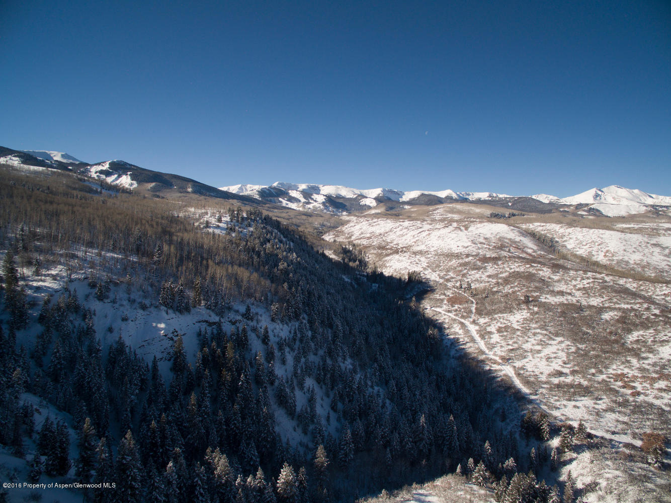4516 Capitol Creek Road Snowmass, CO 81654 - Photo 26 of 59 a view of a large building with mountains in the background