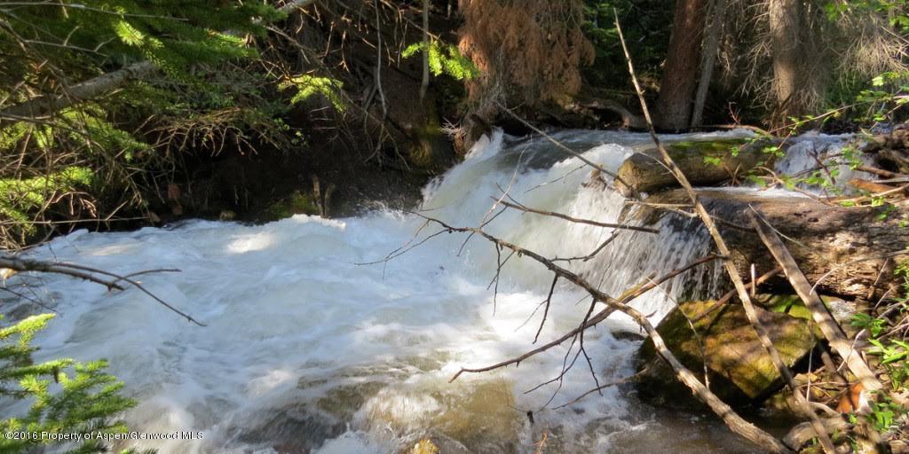 4516 Capitol Creek Road Snowmass, CO 81654 - Photo 31 of 59 a view of backyard with a table and chairs and a fire pit