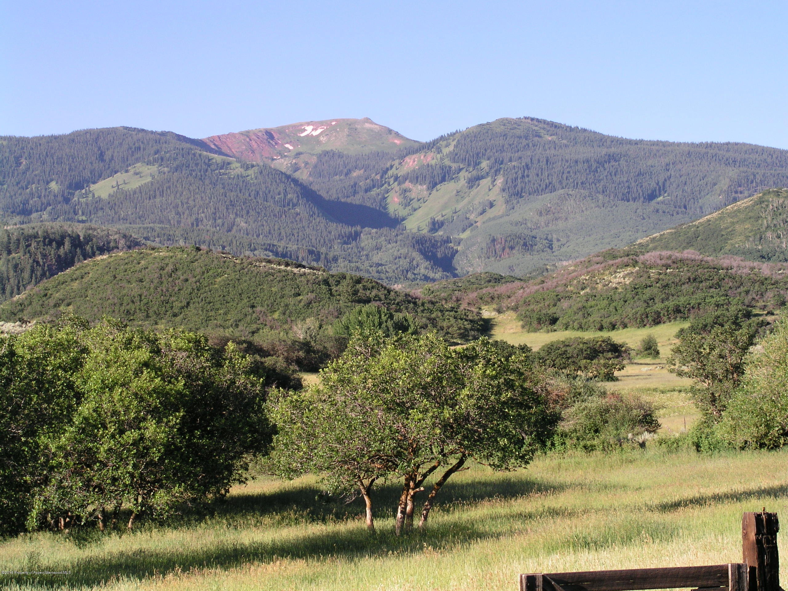 4516 Capitol Creek Road Snowmass, CO 81654 - Photo 43 of 59 a view of a lake with mountains in the background