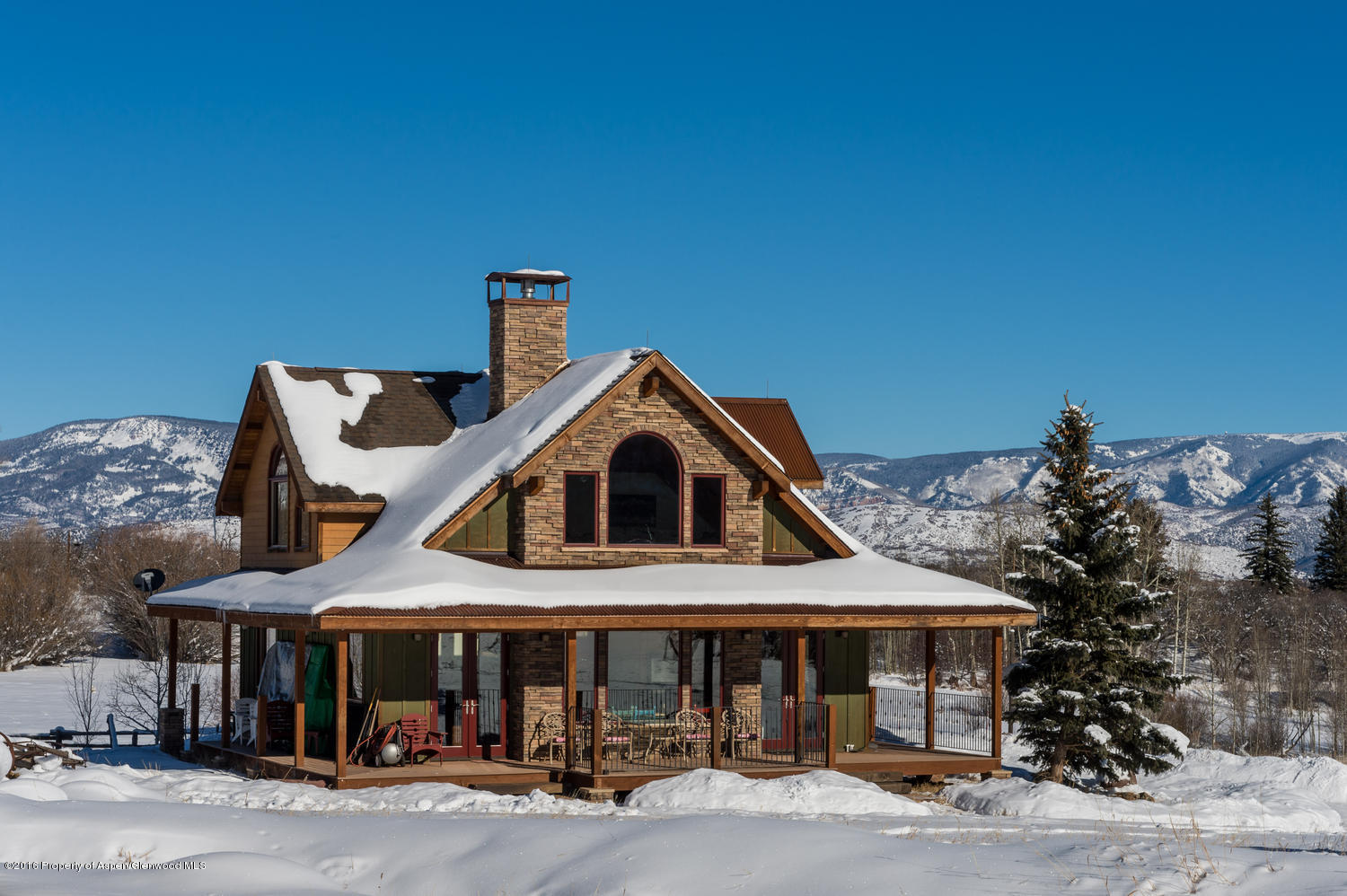 4516 Capitol Creek Road Snowmass, CO 81654 - Photo 7 of 59 a front view of a house with a yard