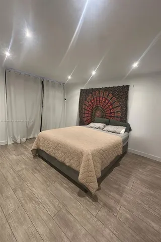 a bedroom with a bed and a night stand