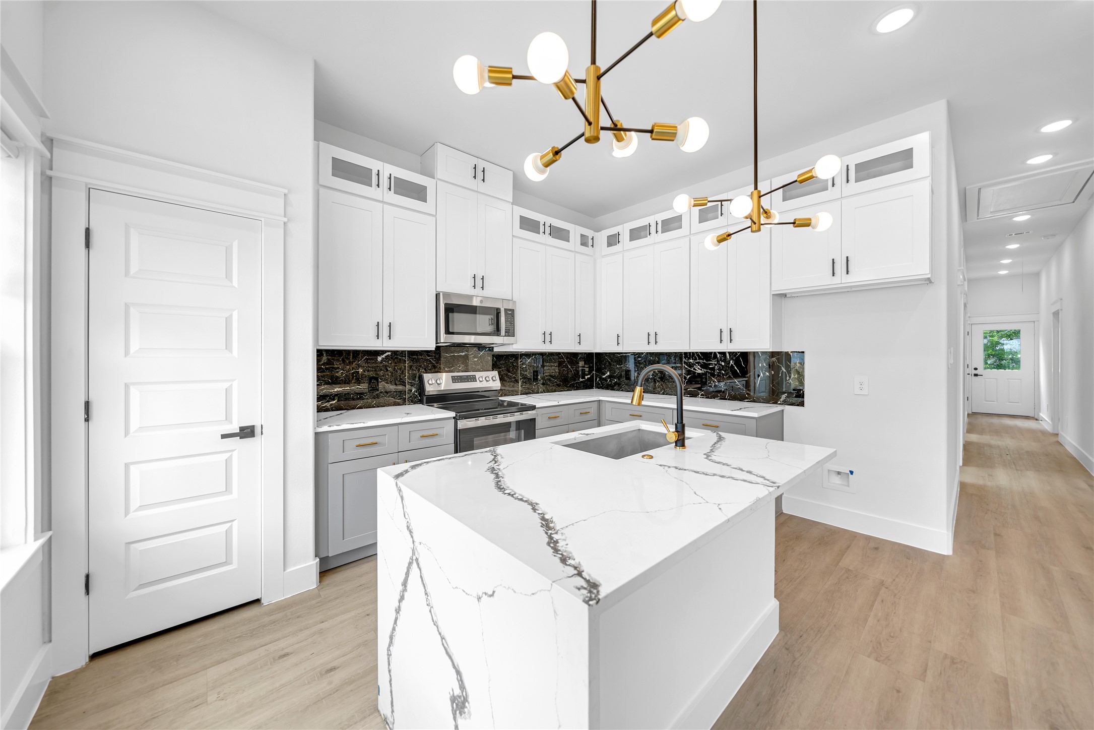 4834 Higgins Street, Unit B Houston, TX 77033 - Photo 7 of 34 a kitchen with a sink a refrigerator and white cabinets
