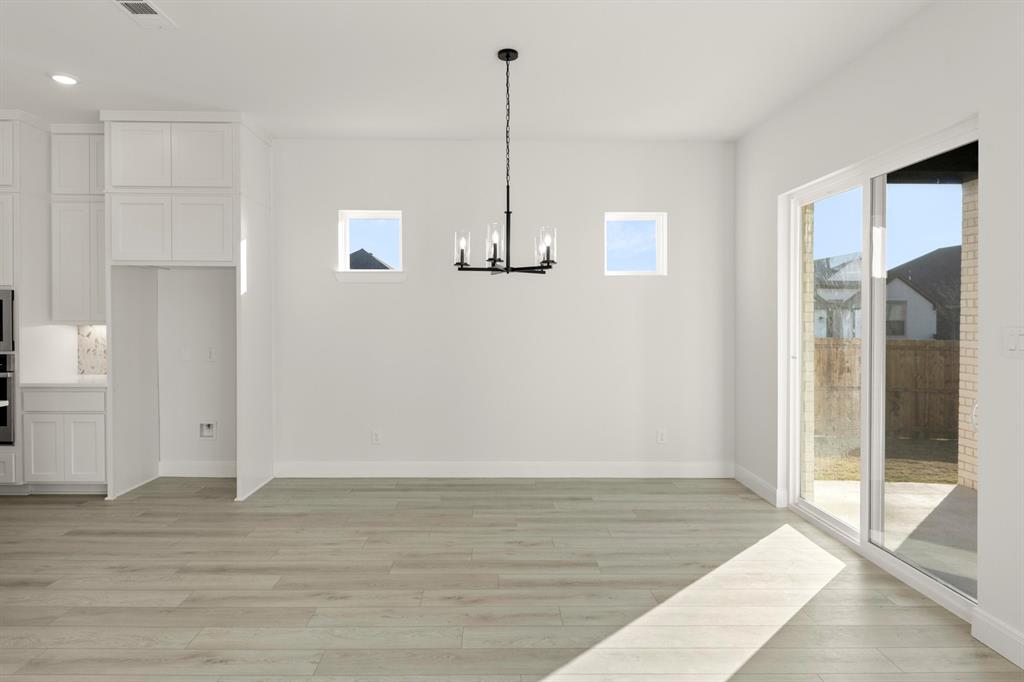 1105 Birdsong Trail Anna, TX 75409 - Photo 12 of 27 a view of a room with wooden floor and window
