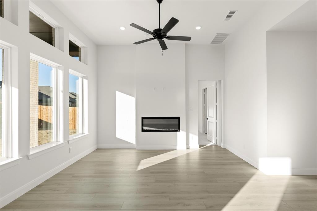 1105 Birdsong Trail Anna, TX 75409 - Photo 14 of 27 wooden floor in an empty room with a window