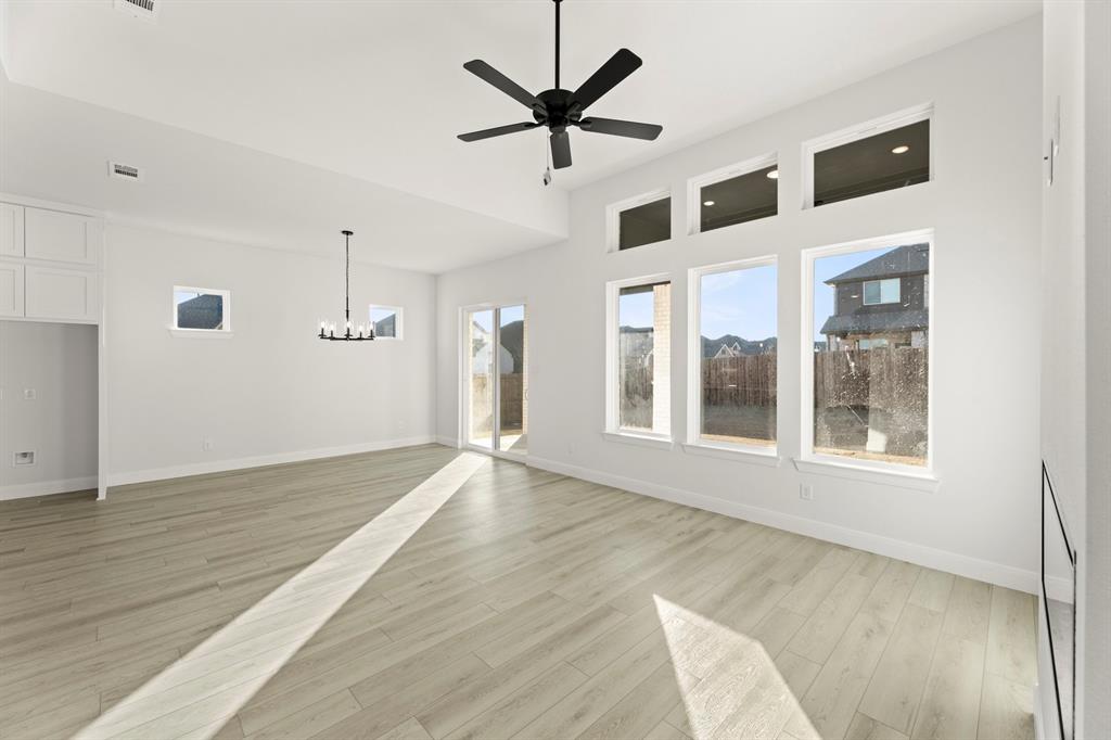 1105 Birdsong Trail Anna, TX 75409 - Photo 16 of 27 a view of an empty room with window and wooden floor
