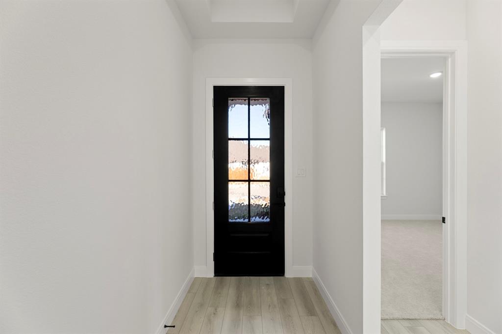 1105 Birdsong Trail Anna, TX 75409 - Photo 2 of 27 a view of an empty room with wooden floor