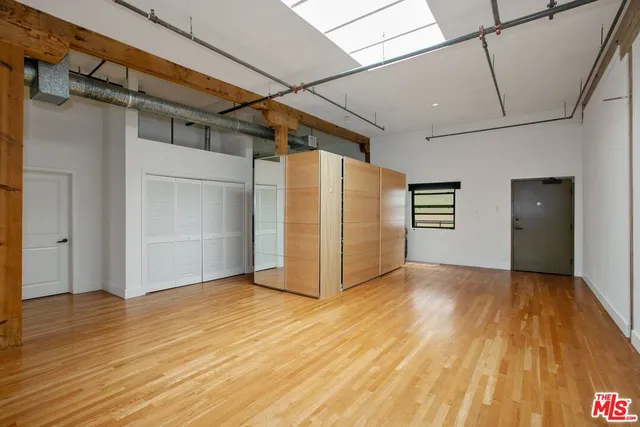 a view of a room with wooden floor