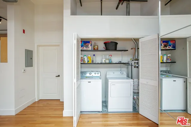 a view of a refrigerator in kitchen and wooden floor