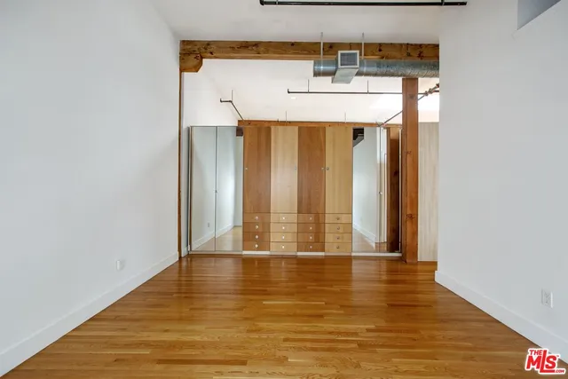 a view of a room with wooden floor and door