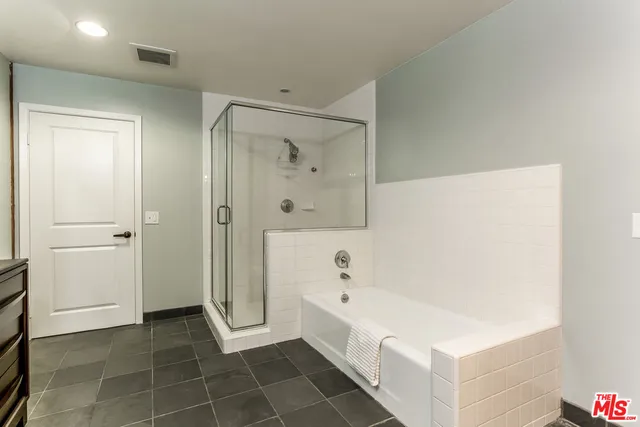 a bathroom with a bathtub and a shower