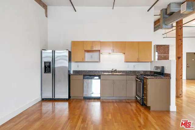 a kitchen with granite countertop a stove and a refrigerator