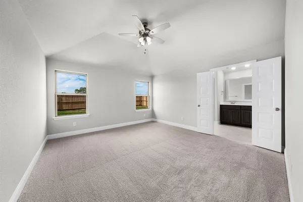 an empty room with a ceiling fan and a window