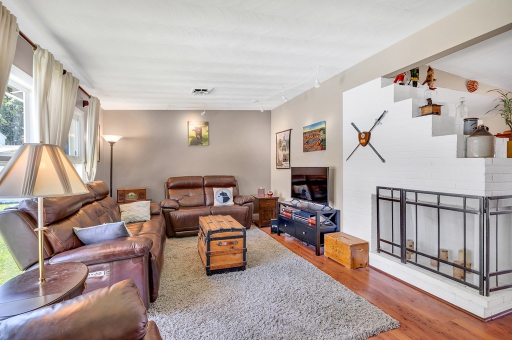 7 Leonard Road Framingham, MA 01701 - Photo 13 of 27 a living room with furniture a flat screen tv and a couch