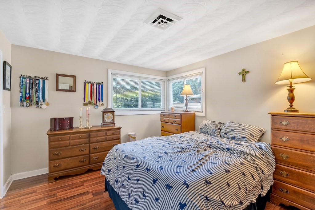 7 Leonard Road Framingham, MA 01701 - Photo 20 of 27 a bedroom with a bed and wooden floor