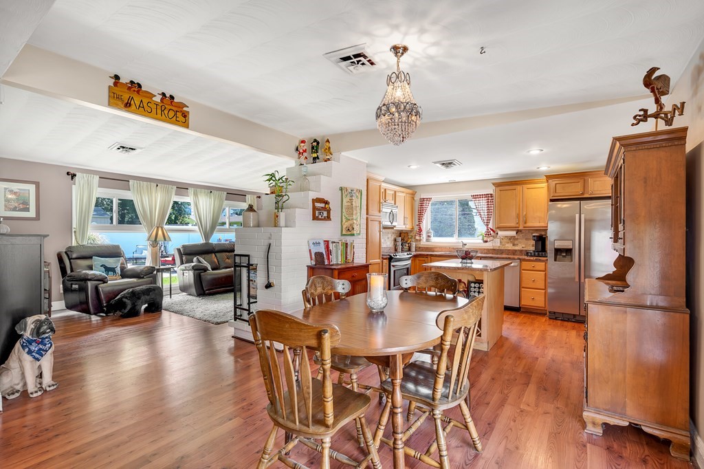 7 Leonard Road Framingham, MA 01701 - Photo 4 of 27 a view of a dining room and livingroom with furniture wooden floor a chandelier