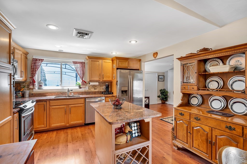 7 Leonard Road Framingham, MA 01701 - Photo 7 of 27 a open kitchen with stainless steel appliances granite countertop a stove and a refrigerator