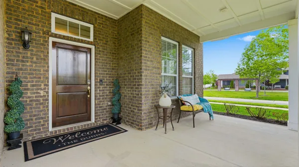 a living room with furniture a flat screen tv and a large window