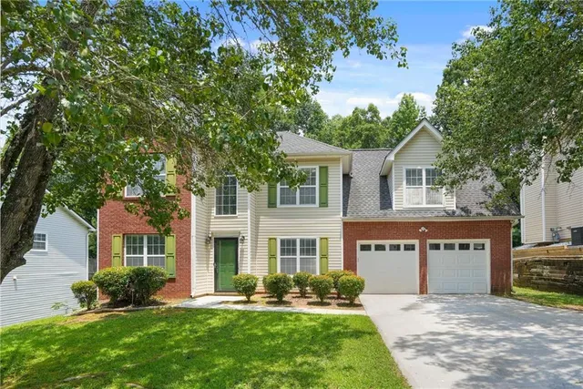 a front view of a house with a yard and porch