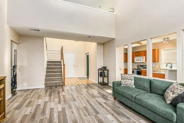 a living room with furniture and wooden floor