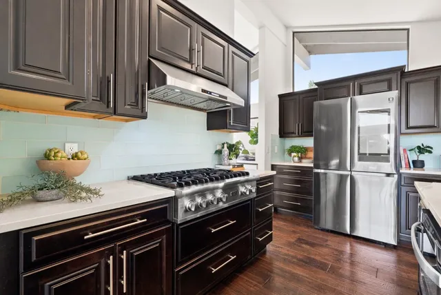 a kitchen with kitchen island a dining table and chairs
