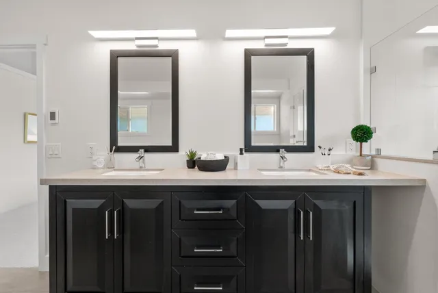 a bedroom with a bed and a potted plant