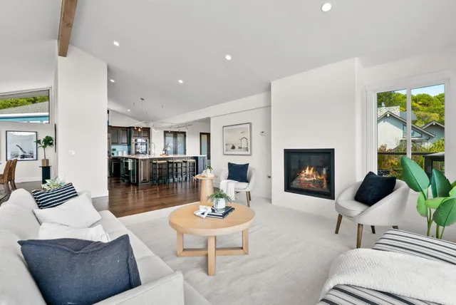 a living room with furniture and large windows