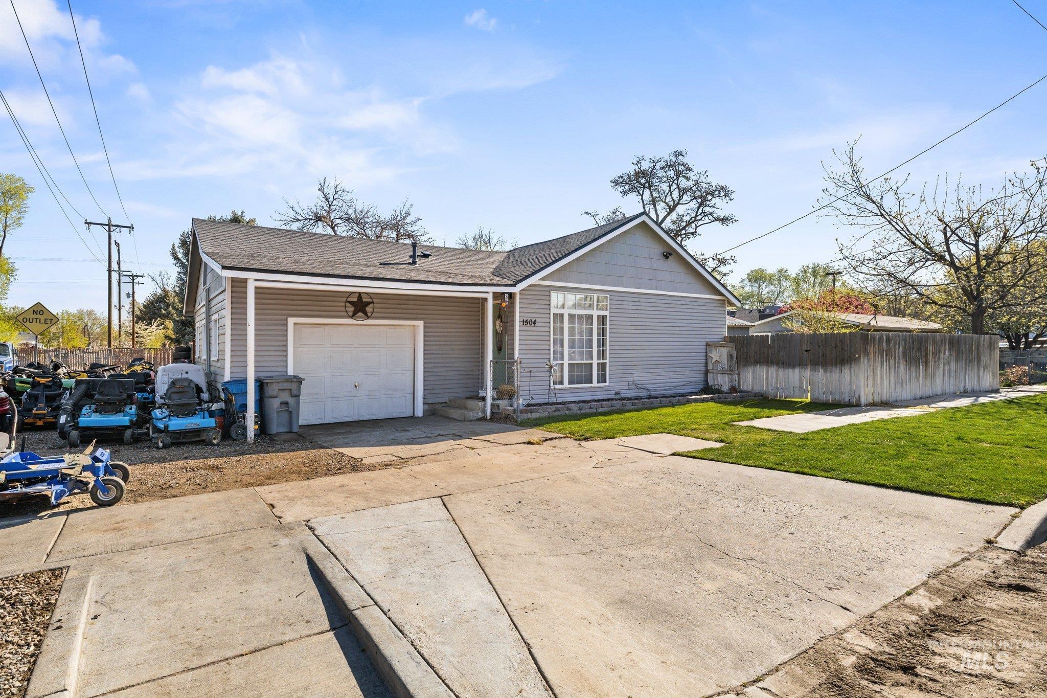 1504 2nd Street North Nampa, ID 83687 - Photo 1 of 29 View of front of property featuring a garage, roof with shingles, and driveway