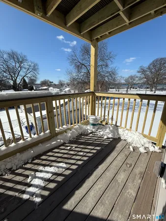 a view of a balcony with wooden floor