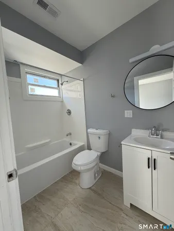 a bathroom with a toilet a sink and bathtub