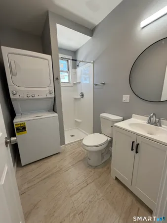 a bathroom with a sink mirror vanity and toilet