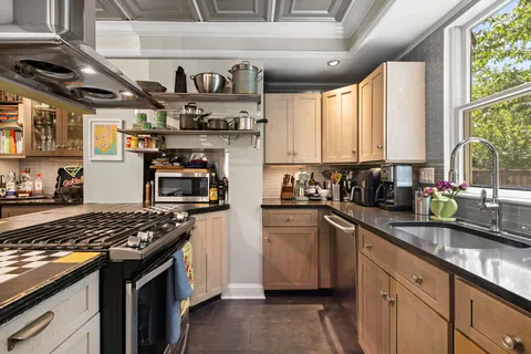 a kitchen with stainless steel appliances granite countertop a stove and a sink