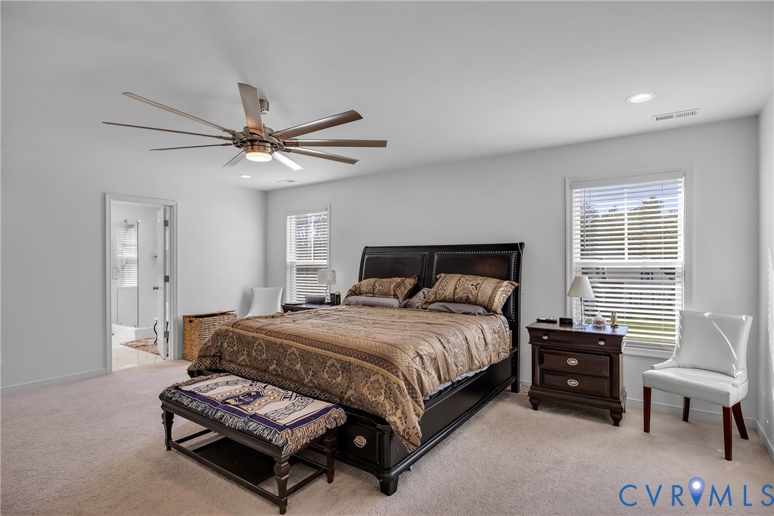 9400 Kinnerton Drive Midlothian, VA 23112 - Photo 17 of 43 a bedroom with a bed and a chandelier