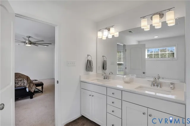 a bathroom with a double vanity sink and a mirror