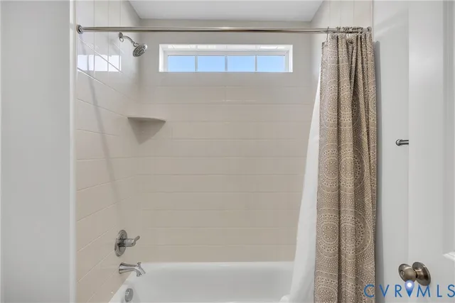 a bathroom with a shower and a tub