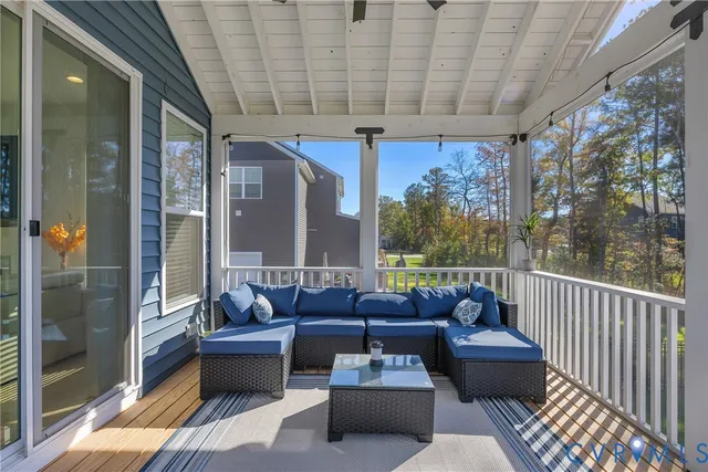 a balcony with furniture and a potted plant